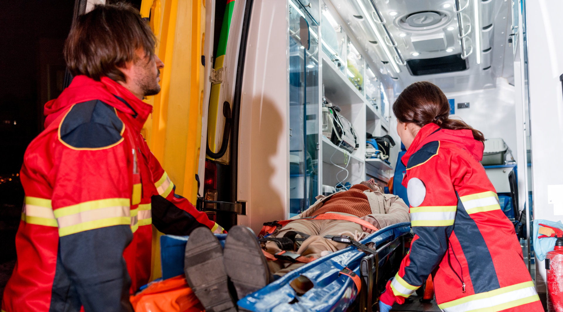 A group of transportation team and a patient on a stretcher